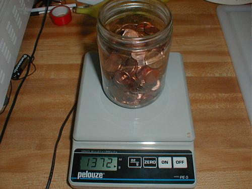 full penny jar on scale weighs 1372 g